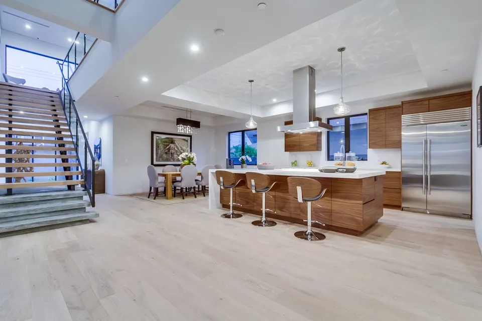 Open kitchen with wood cabinetry and an island